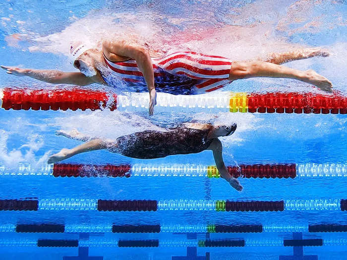 4/11: Katie Ledecky passes an opponent in the opposite direction during the Women