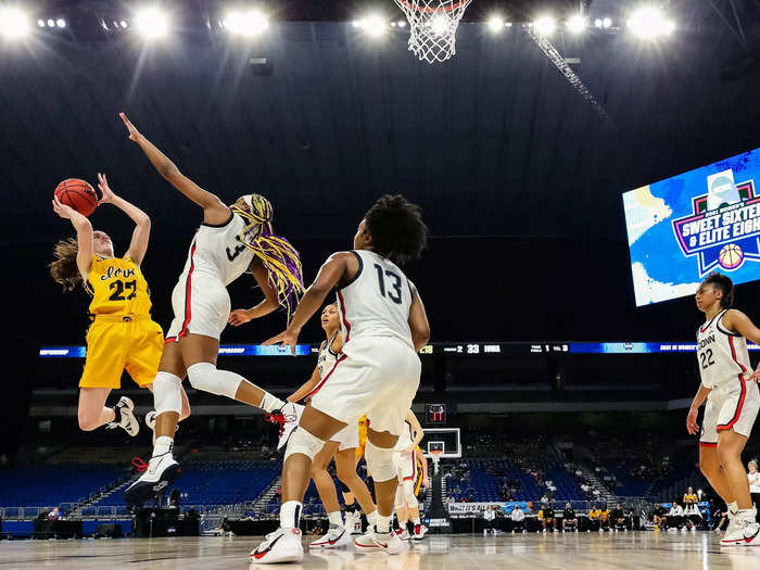 3/27: Iowa Hawkeyes star Caitlin Clark puts up a shot against the UConn Huskies during their Sweet Sixteen matchup.