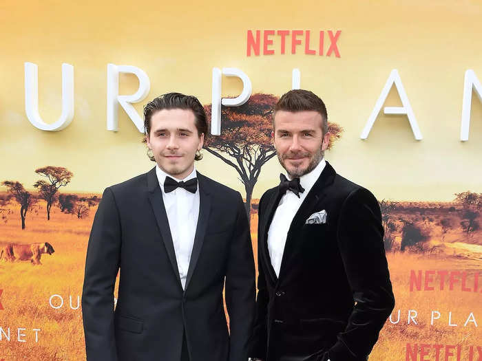 Brooklyn Beckham and his dad David Beckham share the same smile and dapper style. Both were on display in April 2019 when they walked a red carpet together.