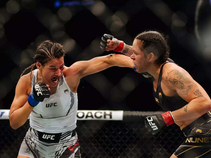 12/11: Julianna Pena (left) punches Amanda Nunes of Brazil in their women