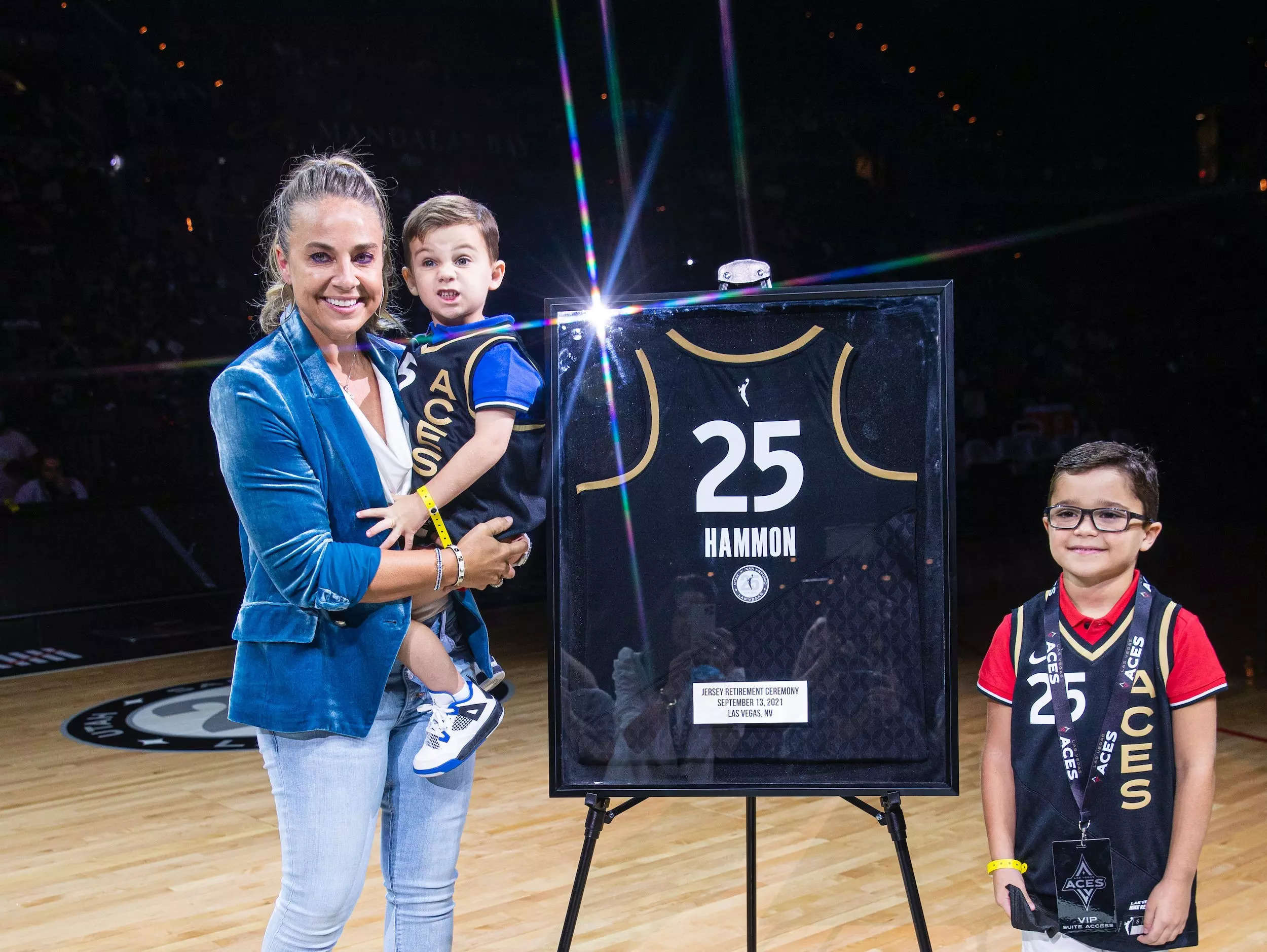 Becky Hammon celebrates with her sons as the Las Vegas Aces retire her jersey.