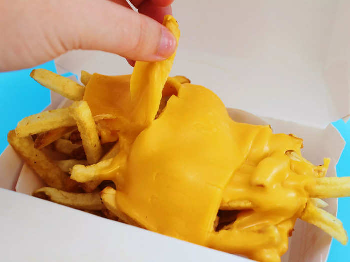 The cheese clung to the top layer of fries.