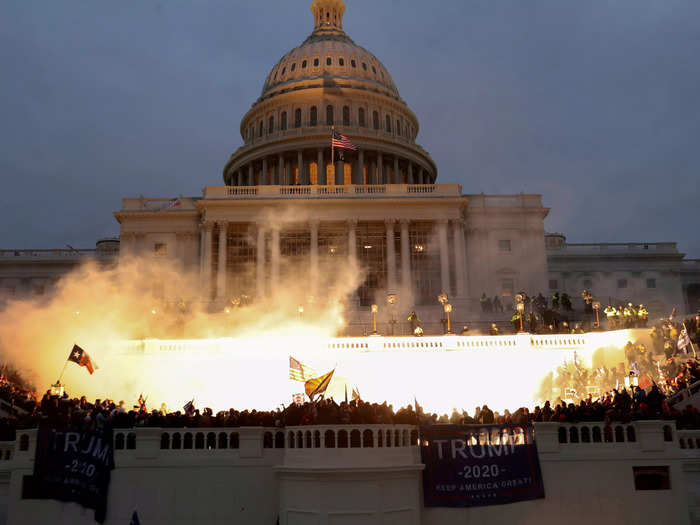 An explosion caused by a police munition is seen while supporters of U.S. President Donald Trump riot in front of the U.S. Capitol Building in Washington, U.S., January 6, 2021.