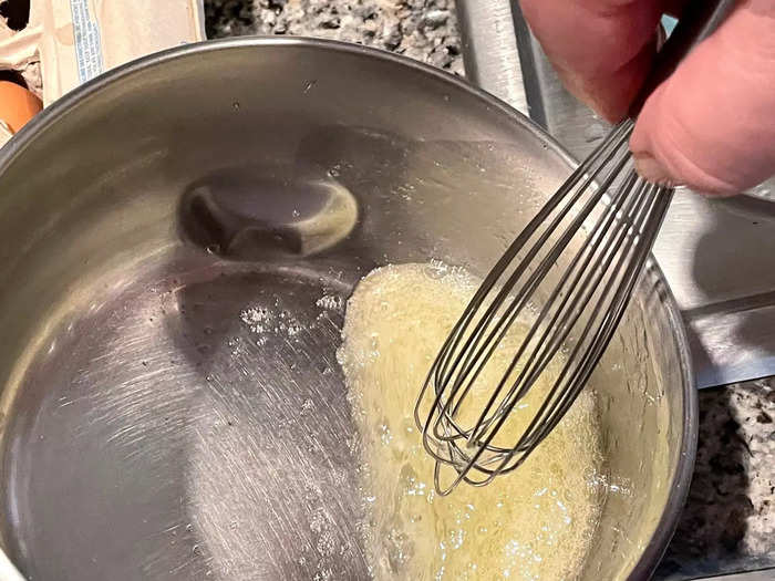 With a whisk or fork, beat the egg whites in the saucepan until they