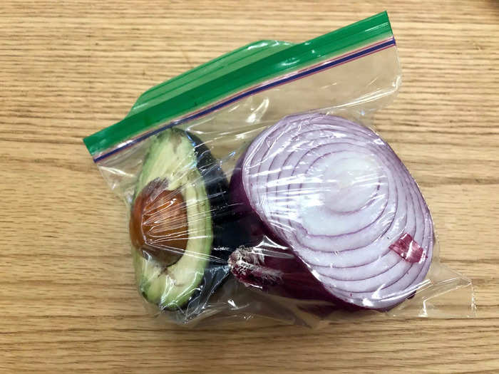 Then I halve an avocado, storing the spare in a bag with my leftover onion for the next day.