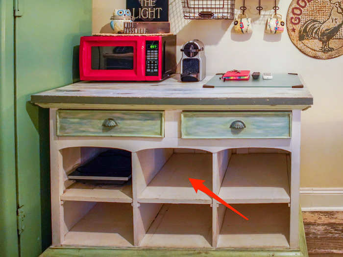 A table with drawers and shelves served as a kitchen counter, as well as storage space.