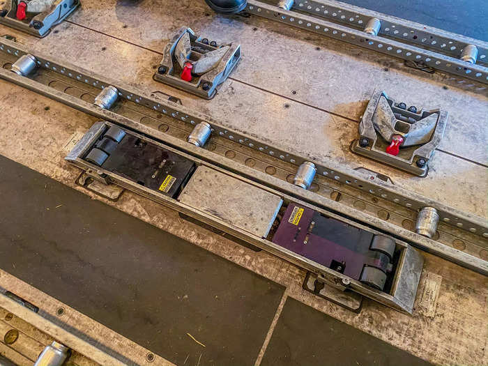 Small wheels on the ground make it so that ground handlers can easily and efficiently move pallets to their assigned locations on the aircraft.