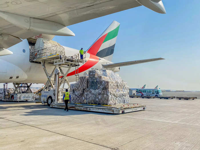 The upper deck of the Boeing 777 Freighter can store 6,800 kilograms of freight per pallet.  Each aircraft requires around 10 ground handlers to service, with heavy machinery doing most of the heavy lifting.