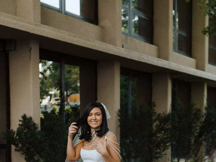 Vora swapped the sheer gloves and polka-dot veil for a pearl shoulder necklace and her mom