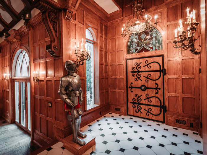 Once inside, the 10,790-square-foot property nods to its Middle Age Scottish baronial theme with a suit of armor by the door.