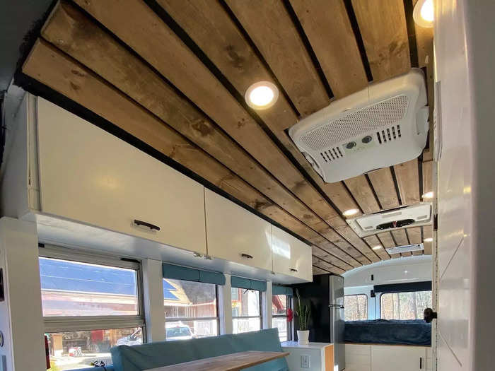 Behind the kitchen is a living area with smart storage hacks like a set of drawers below the couch.