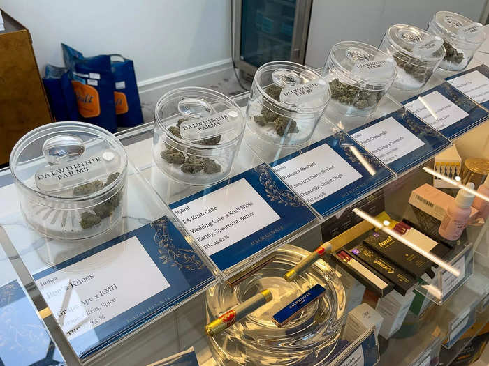 On the counter is a row of cannabis flower grown at the company