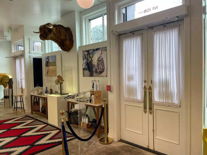 Beyond the high-end shelves is decor that fits into the theme of abundance. A mounted buffalo head towers over customers and a life-sized gold horse fills a corner.