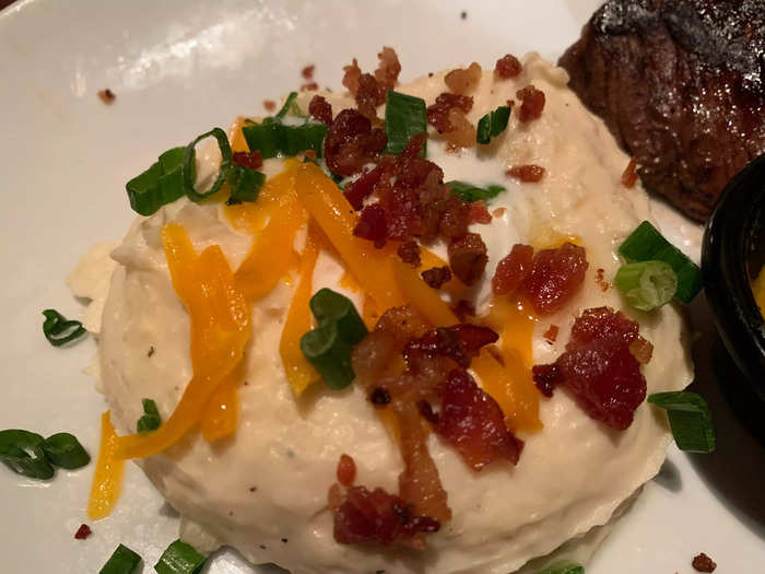 The mashed potatoes were excellent, with a smooth whipped texture topped with bacon, green onions, cheese, and a garlic butter.