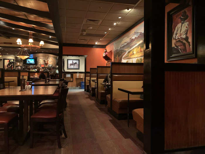 The dining room interior felt cozy, with dark woods and warm lighting.