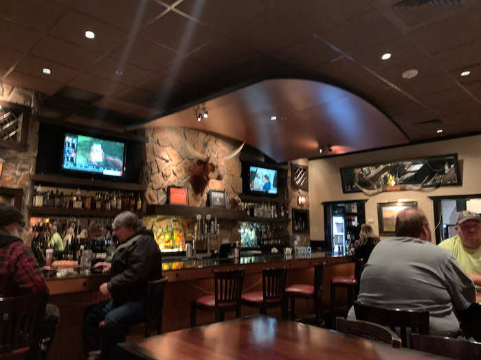 The front of the restaurant has a sports bar feel to it, with TVs playing sports and high-top tables.