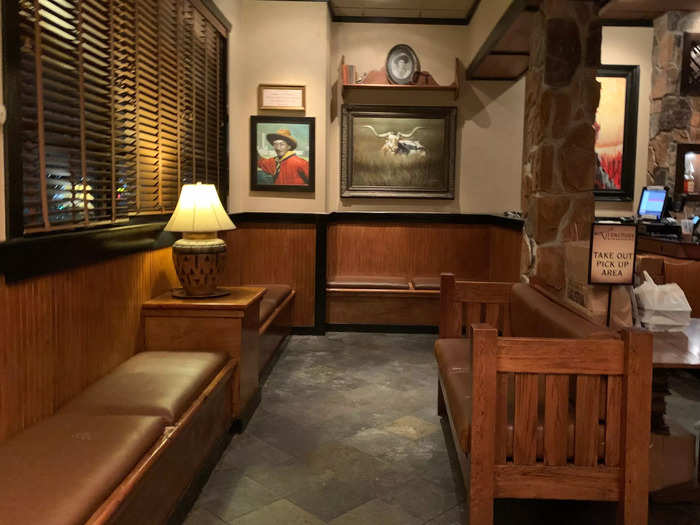 The entryway was built to accommodate a large number of waiting customers in wood-paneled seats and benches.