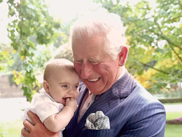 After the formal portrait, he also took a photo of Prince Charles holding Prince Louis.