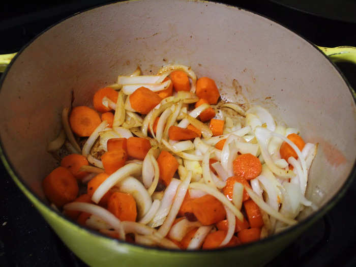 I then added the sliced onions and carrots to the Dutch oven.