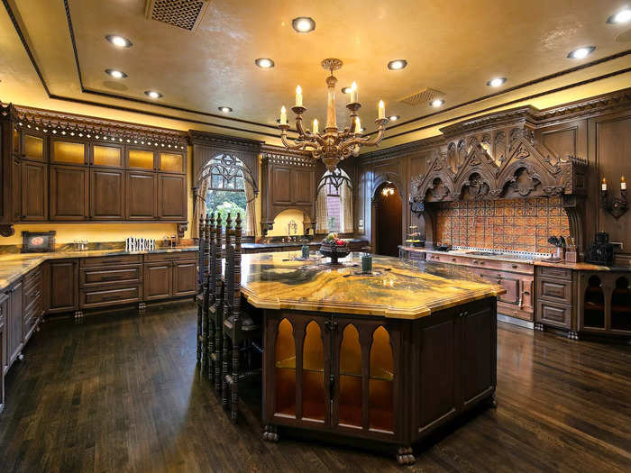 It also connects to a "chef-quality kitchen" decorated with dark wood and marble, according to the Sher Group.
