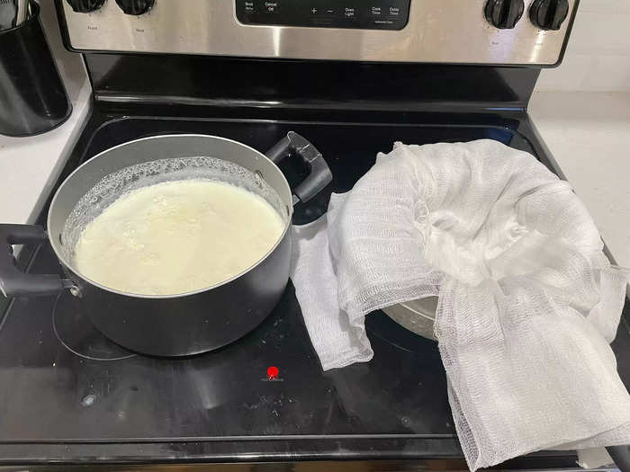 Next, pour the curdled milk into a sieve covered by a cheesecloth.