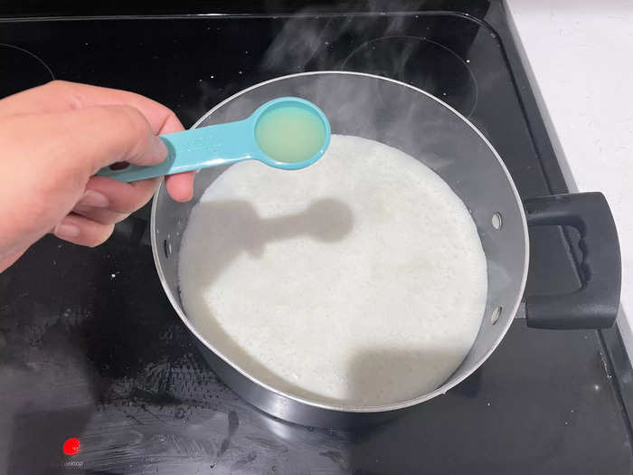 Step two is to add a dash of lemon juice before the curds form.