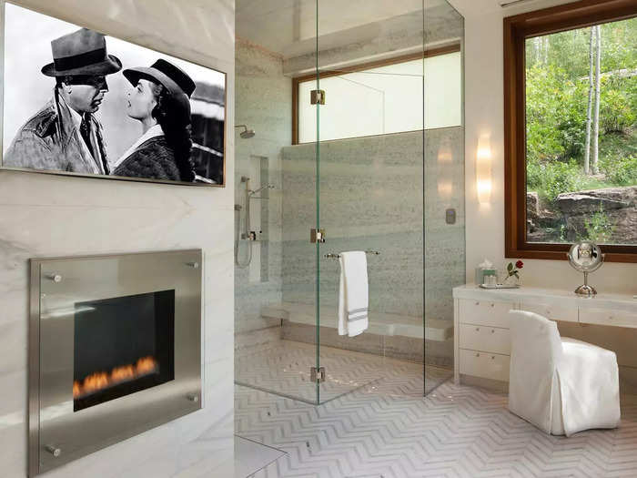 Each of these bathrooms have a fireplace, steam shower, and TV. In one bathroom, there