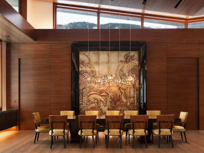 The grand room connects to the dining room, which features an intricate animal mosaic. The room