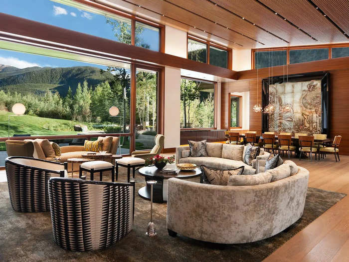 The open layout and floor-to-ceiling windows seamlessly connect the room to the outdoors.