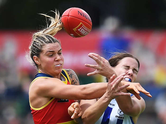 1/16: Anne Hatchard of the Adelaide Crows goes up against the North Melbourne Kangaroos