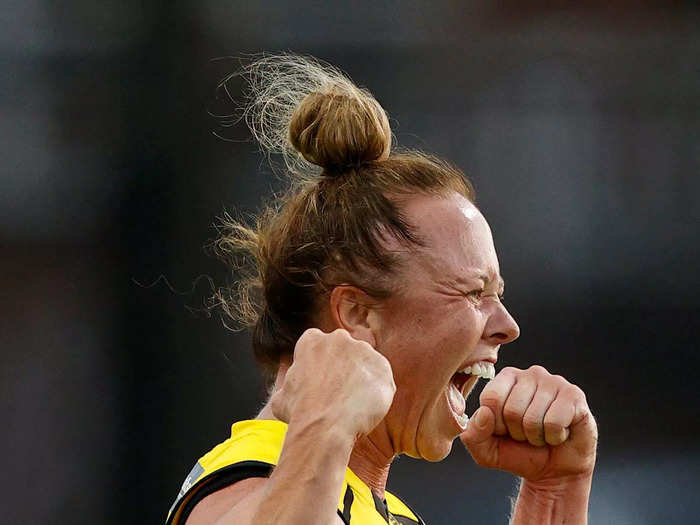 1/7: Richmond Tiger Courtney Wakefield celebrates a goal against the St Kilda Saints during an AFLW match.