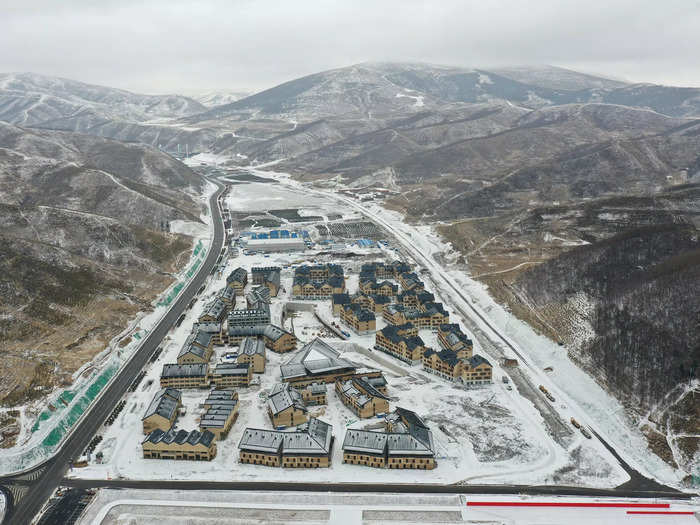 These villages, like the competition venues, are shrouded in fake snow, per the BBC.