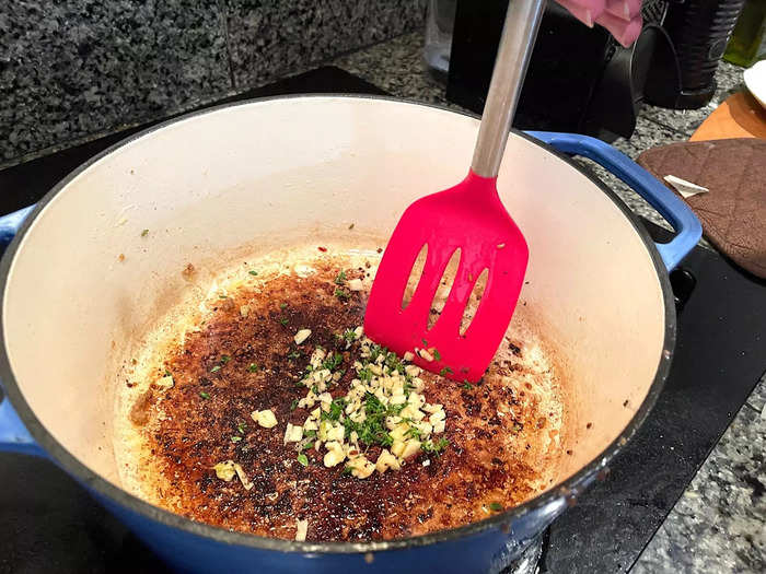 I drained the excess fat from my Dutch oven before adding the chopped garlic and thyme.