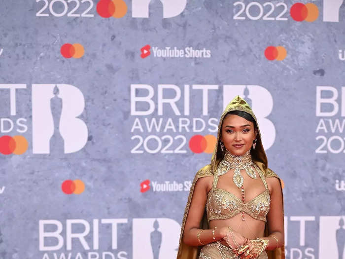 Musician Joy Crookes looked like royalty in a gold ensemble.