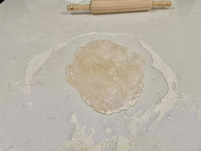 Flatten each section into a large thin sheet using a rolling pin.
