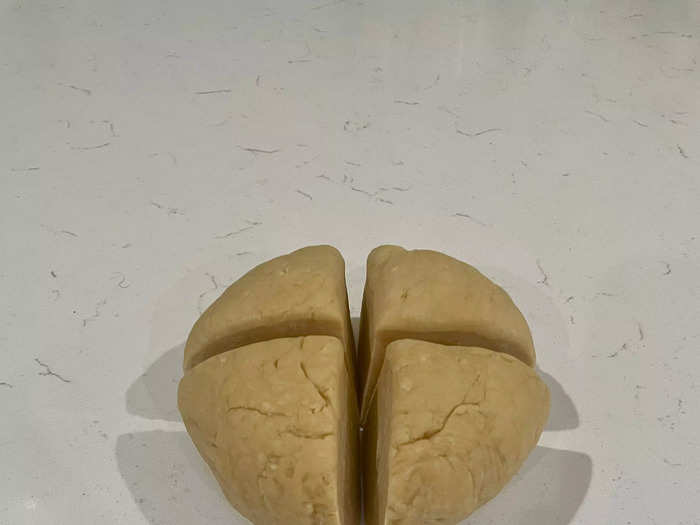 Remove the dough from the fridge and cut it into four sections.