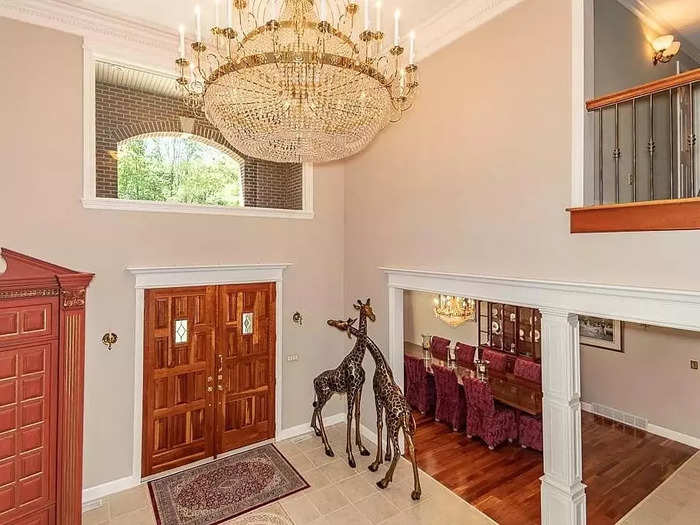 Alongside the curved staircase is a huge crystal chandelier.