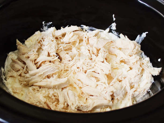 I then added a layer of shredded chicken to the slow cooker.