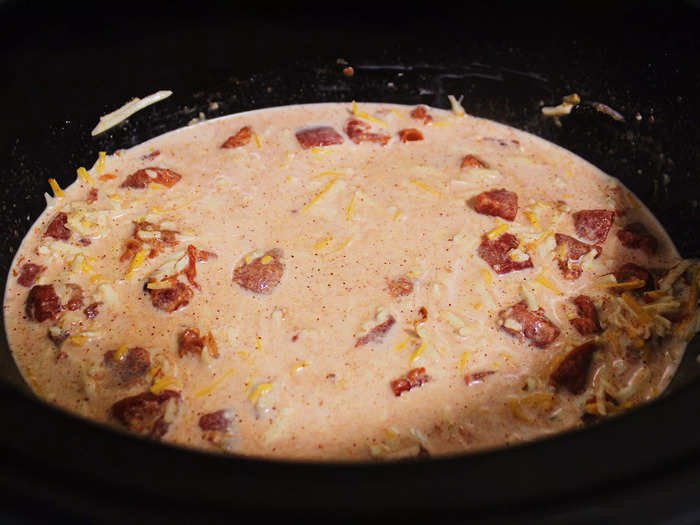 After putting cheese in the slow cooker, I added a can of evaporated milk and a can of diced tomatoes with chilies.