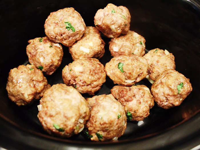 The meatballs fit nearly in a single layer inside the slow cooker.