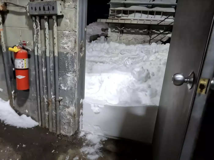 Back at the garage, the effect of the wind-driven accumulation can be seen against the door.