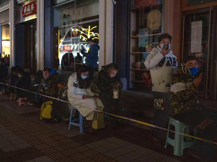 At night, they hunker down, sometimes in freezing temperatures, in anticipation of the store openings the next day, bringing stools to ease the wait.