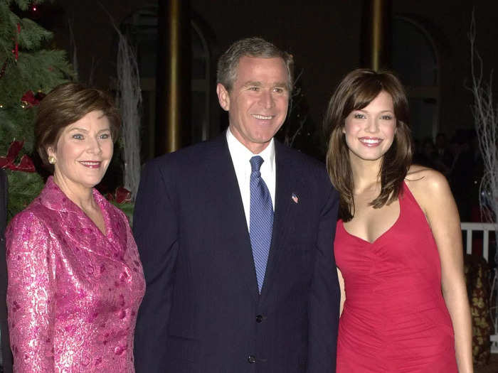 Mandy Moore looked elegant when she met George W. Bush and Laura Bush in 2001. She wore a sleeveless red gown with a high-low skirt and a V neckline.