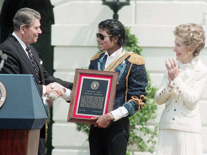 Michael Jackson stole the show when accepting an award from the 40th US president in 1984. He wore a jacket covered with blue sparkles, gold epaulets, and a matching sash.