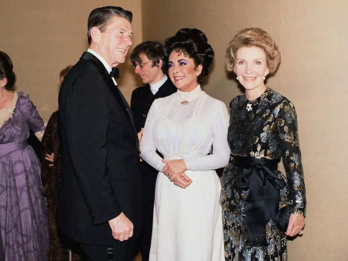 During his early days in office, Ronald Reagan met Elizabeth Taylor. She wore a baby-blue dress with a semi-sheer top and high neckline that day.