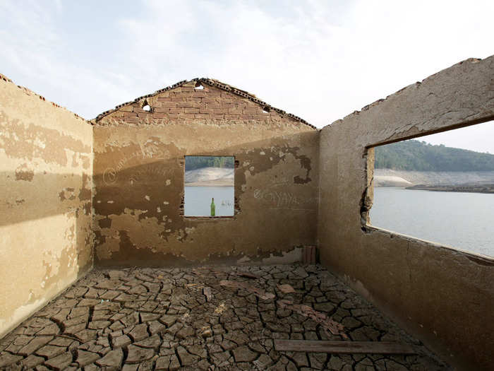 There are signs of life that once occupied the village, including an old cafe, a drinking fountain that is still spewing water, and a rusty car.