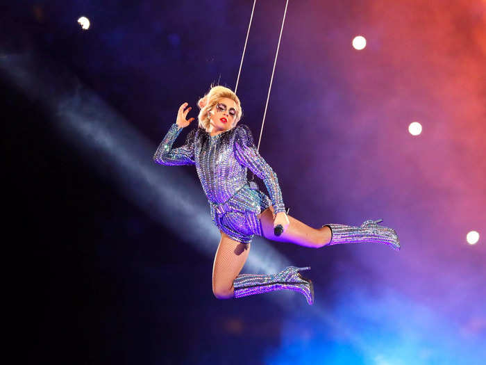 Lady Gaga dived into her Super Bowl halftime show in 2017 wearing a bedazzled Versace bodysuit and matching boots.