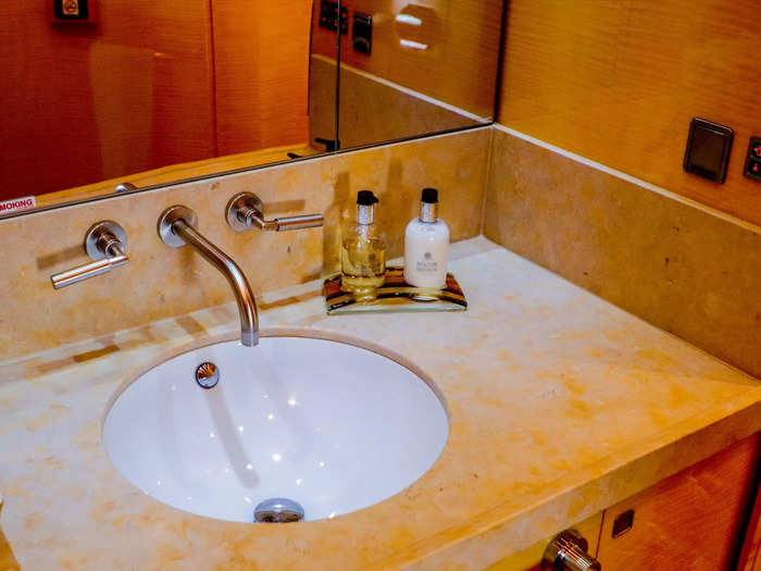 Inside the bathroom is a full vanity and walk-in shower, another key differentiator between airliner private jets and traditional private jets.