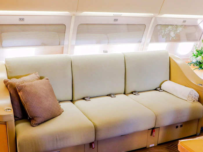 A divan sits opposite the main table and can seat three passengers in a more informal setting.