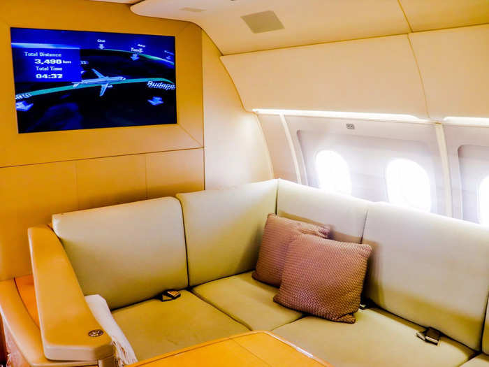 Above the living room is a large television screen that can be used for entertainment, to keep track of the aircraft